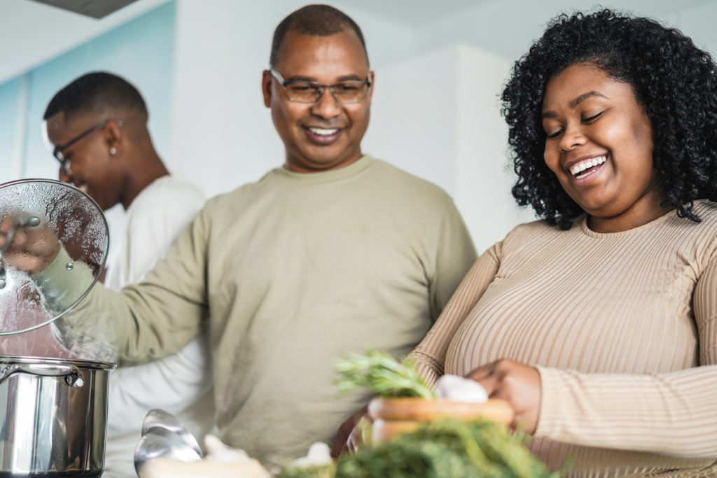 Happy dad and daughter cooking at home